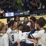 The Homer volleyball team gathers for a group hug Saturday, Nov. 16, 2019, after winning the Class 3A state volleyball tournament at the Alaska Airlines Center in Anchorage, Alaska. (Photo by Joey Klecka/Peninsula Clarion)