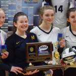 Members of the Homer volleyball team hold up the Class 3A state championship trophy Saturday at the Class 3A state volleyball tournament at the Alaska Airlines Center in Anchorage. (Photo by Joey Klecka/Peninsula Clarion)