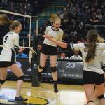 The Homer volleyball team celebrates after scoring the final point Saturday, Nov. 16, 2019, against Kenai Central at the Class 3A state volleyball tournament at the Alaska Airlines Center in Anchorage, Alaska. (Photo by Joey Klecka/Peninsula Clarion)