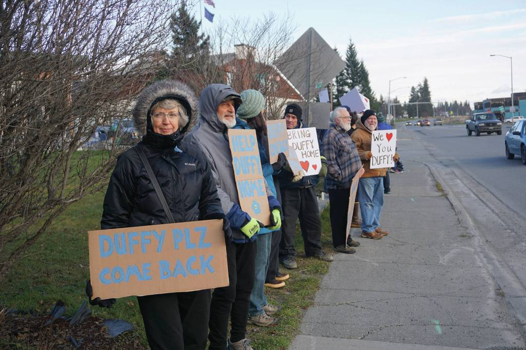 People hold signs Saturday, Nov. 23, 2019, at a vigil for Anesha Duffy Murnane, a Homer woman missing since Oct. 17, at WKFL Park in Homer, Alaska. (Photo by Michael Armstrong/Homer News)