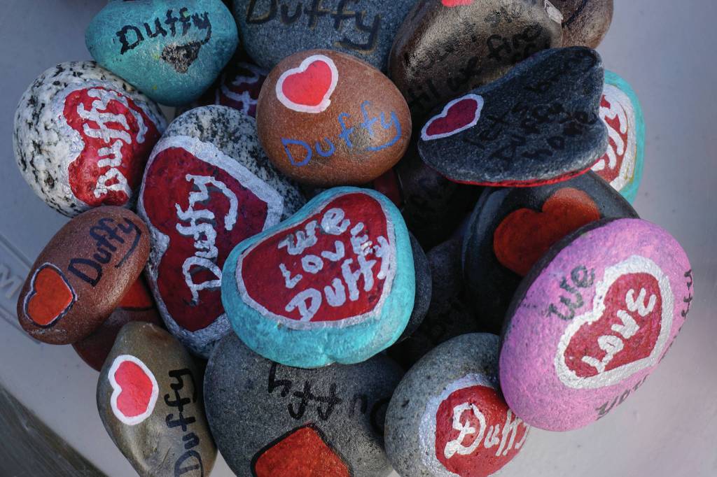 A bowl of painted rocks were given out Saturday, Nov. 23, 2019, at a vigil for Anesha Duffy Murnane, a Homer woman missing since Oct. 17, at WKFL Park in Homer, Alaska. (Photo by Michael Armstrong/Homer News)