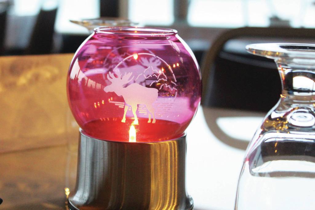 A candle lights a table at a community Thanksgiving dinner Thursday, Nov. 28, 2019 at the Homer Elks Lodge in Homer, Alaska. (Photo by Megan Pacer/Homer News)