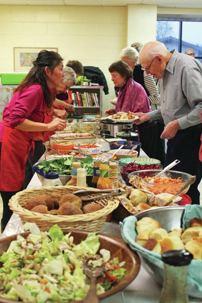 Members of the community line up to enjoy some food at a free Thanksgiving dinner Thursday, Nov. 28, 2019 at Homer United Methodist Church in Homer, Alaska. (Photo by Megan Pacer/Homer News)