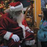 Emma Rader, 6, talks to Santa Claus before getting her photo taken with him at the annual Holiday Tree Lighting event put on by the Homer Chamber of Commerce and Visitor Center on Thursday, Dec. 5, 2019 at the chamber in Homer, Alaska. (Photo by Megan Pacer/Homer News)