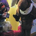 Lev Meyers, 3, shows a piece of chocolate handed out by Homer Truffle Co. to a large, festive moose at this years Holiday Tree Lighting event put on by the Homer Chamber of Commerce and Visitor Center on Thursday, Dec. 5, 2019 at the visitor center in Homer, Alaska. (Photo by Megan Pacer/Homer News)