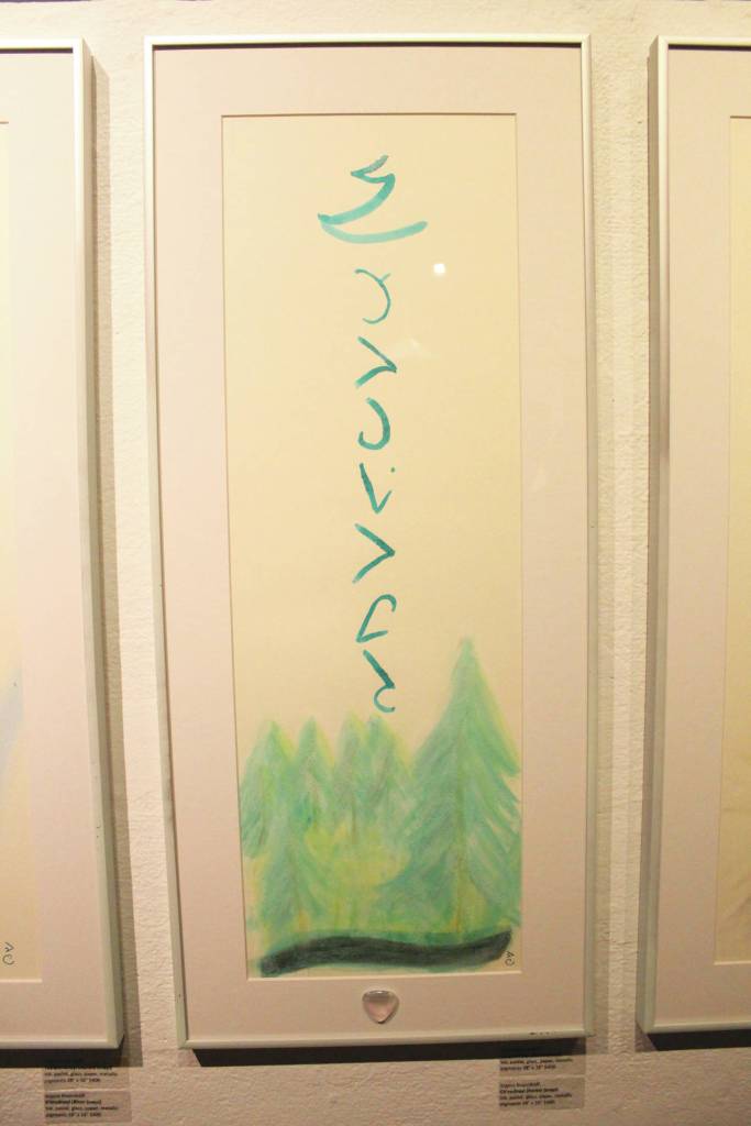 Paintings called Dnayi scrolls hang on a wall at the Bunnell Street Arts Center during an art exhibit opening Friday, Dec. 6, 2019 featuring the work of Argent Kvasnikoff in Homer, Alaska. The scrolls are calligraphic paintings depicting natural phenomena, like water or mountains. (Photo by Megan Pacer/Homer News)