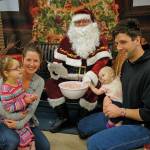 Sydney Jones, left, with her mother, Sarah Bollwitt, visits with Santa Claus on Sunday, Dec. 8, 2019, at the Homer Nutcracker Faire at Homer High School in Homer, Alaska. Sydneys father, Morgan Jones, right, and sister, Jenaka, watch. Sydney had her mother write a letter to Santa Claus for her. (Photo by Michael Armstrong/Homer News)