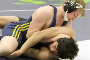 Homers Edson Knapp works to turn Sewards Lucas Brockman during a consolation match at 171 pounds on the first day of the Kachemak Conference Championships Friday, Dec. 13, 2019, at Redington Jr/Sr High School. (Photo by Tim Rockey/Frontiersman)