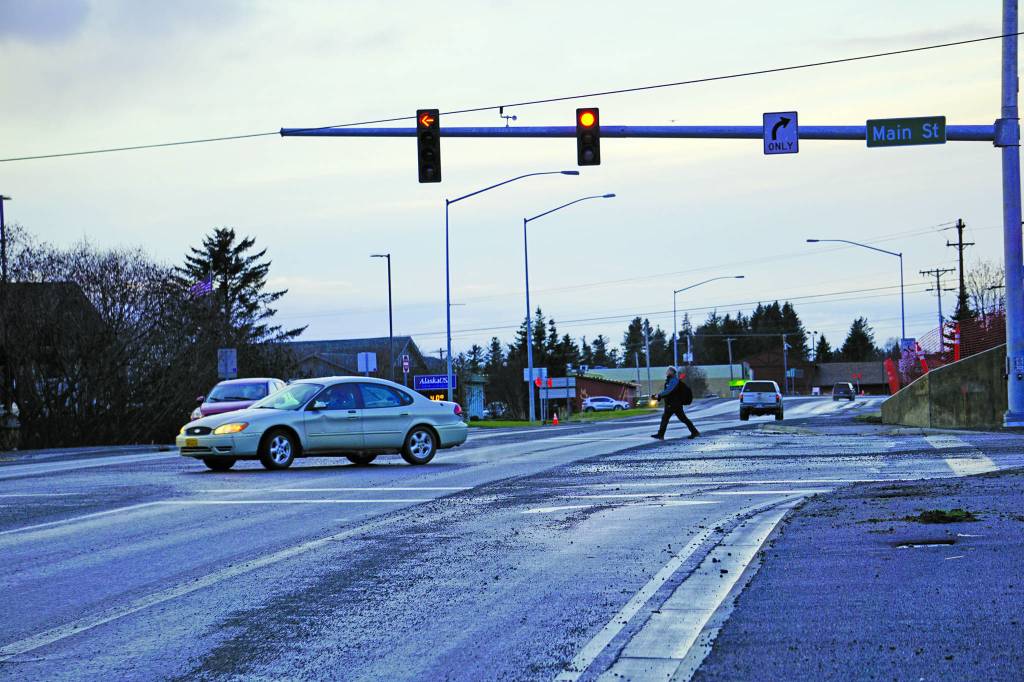 A man crosses the Homer Bypass Road as a driver turns left from Main Street onto the bypass using the new stoplight at the intersection. Homers second stoplight became operational on Tuesday, Dec. 10, 2019, in Homer, Alaska. (Photo by Michael Armstrong/Homer News)