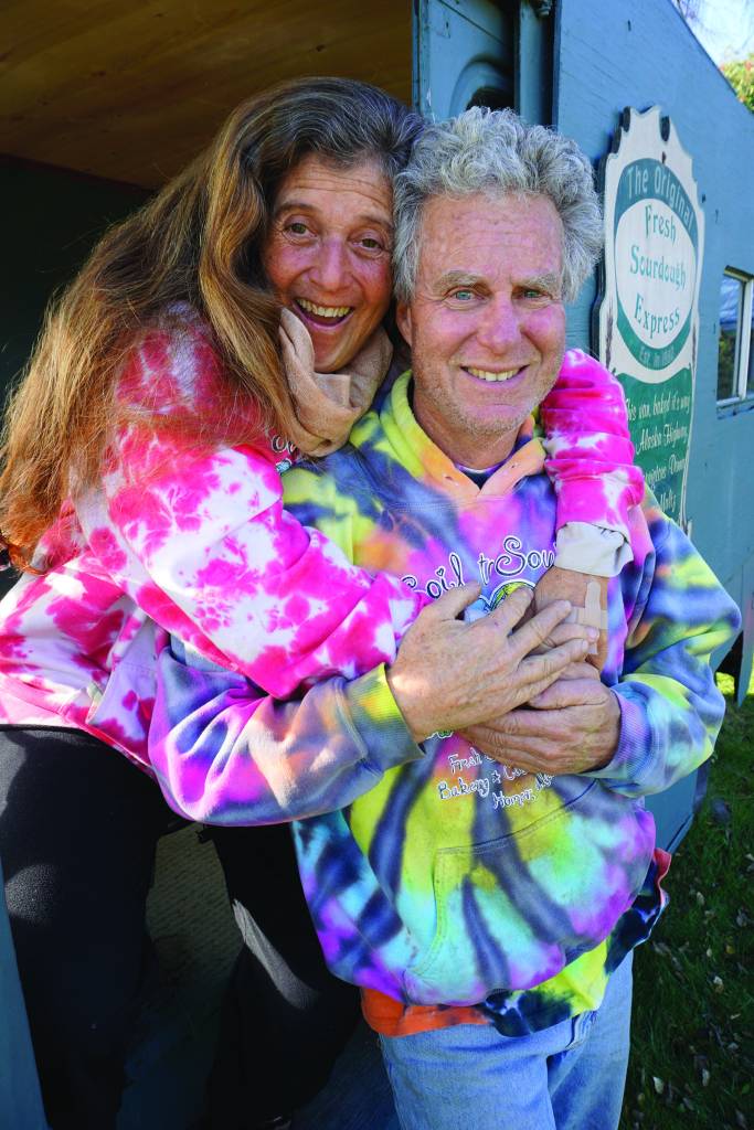 Donna and Kevin Maltz pose in the original Fresh Sourdough Express Bakery and Cafe van on Sept. 27, 2019, as the landmark business held a going-out-of-business garage sale at its Ocean Drive location in Homer, Alaska. (Photo by Michael Armstrong/Homer News)