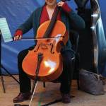 Nancy L. Ives, principal cellist for the Oregon Symphony Orchestra, Portland, plays for students at Little Fireweed Academy on Friday, Dec. 20, 2019, in Homer, Alaska. Ives talked with the students about cycles, a theme they have been studying this year, and how they fit in music. She also performed for a concert fundraiser at the Pratt Museum that night. (Photo by Michael Armstrong/Homer News)