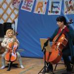 Nancy L. Ives, principal cellist for the Oregon Symphony Orchestra, Portland, plays with Lila Shavelson at Little Fireweed Academy on Friday, Dec. 20, 2019, in Homer, Alaska. Ives talked with Fireweed students about cycles, a theme they have been studying this year, and how they fit in music. She also performed for a concert fundraiser at the Pratt Museum that night. (Photo by Michael Armstrong/Homer News)