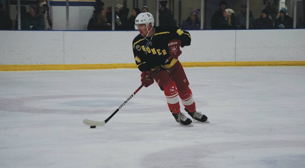 Tom Bowe, Homer High School 2014, works the puck during an alumni/alumnae hockey game last Friday, Dec 27, 2019, at the Kevin Bell Ice Arena in Homer, Alaska. (Photo by Michael Armstrong/Homer News)