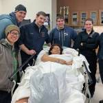 Members of the Homer Volunteer Fire Department pose with new parents Stephanie Cozadd-Pearson (center, foreground) and Jasiah Carlson (third from the right) after helping deliver the first baby born in Homer, Alaska in 2020, Ariyana Carlson. Cozadd-Pearson delivered at home on Jan. 2, 2020 with the help of the medics when she realized she and Carlson would not make it to the hospital in time. (Photo courtesy Assistant Fire Chief Dan Miotke)