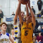Ninilchiks Tom Nelson (5) gets a block from CIAs Josh Boyd, Tuesday, Jan. 7, 2020, at Cook Inlet Academy in Soldotna, Alaska. (Photo by Joey Klecka/Peninsula Clarion)