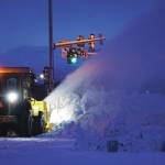 A City of Homer worker operates a snowblower on Friday morning, Jan. 3, 2020, to clear snow piles a the snow dump near the Lake Street and Sterling Highway intersection in Homer, Alaska. (Photo by Michael Armsrong/Homer News)
