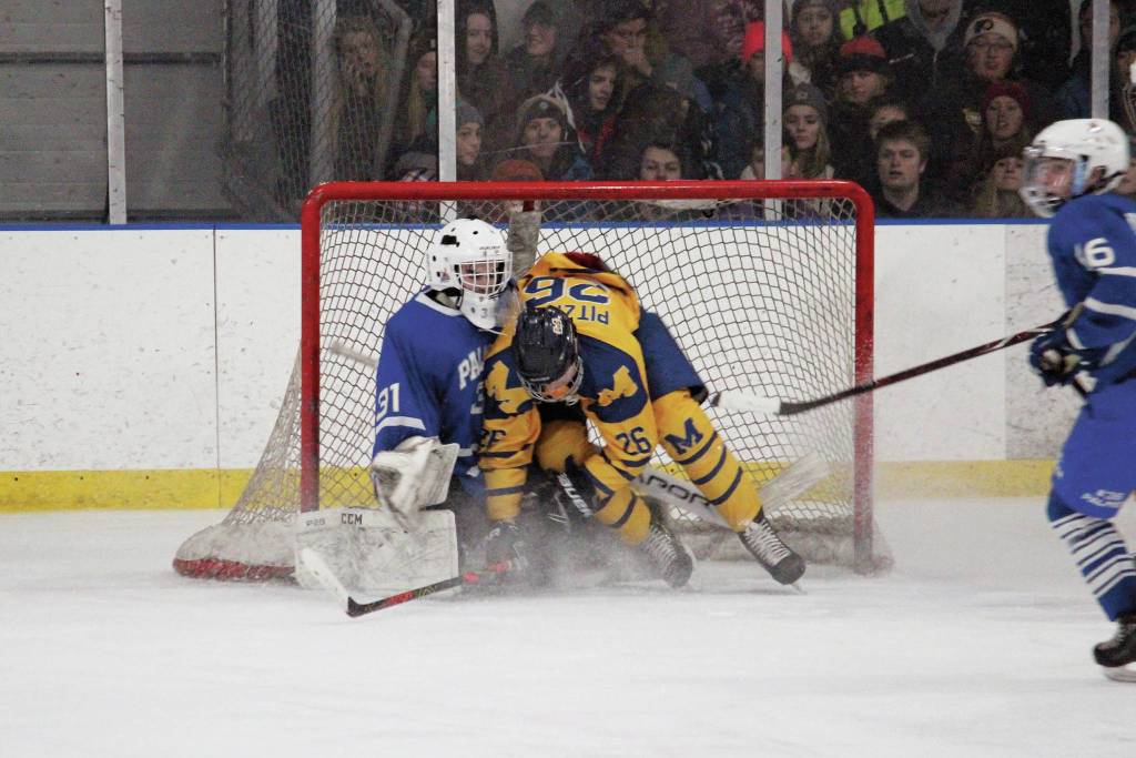 Homers Ethan Pitzman crashes into the net and into Palmer goaltender Tiernan ORourke after an unsuccessful shot on goal Thursday, Jan. 9, 2020 during a hockey game at Kevin Bell Arena in Homer, Alaska. (Photo by Megan Pacer/Homer News)