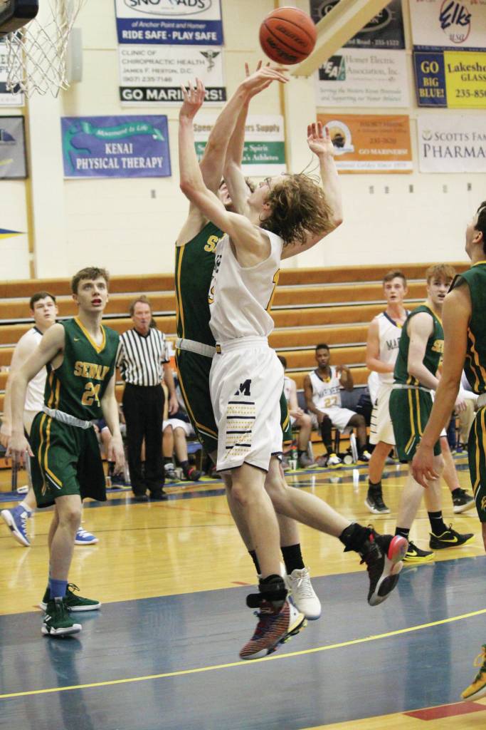 Homers Jonathan Raymond goes up for a shot during a Saturday, Jan. 11, 2020 basketball game against Seward High School in the Alice Witte Gymnasium in Homer, Alaska. (Photo by Megan Pacer/Homer News)