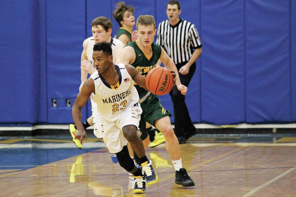 Homers Eyoab Knapp takes the ball down the court with Sewards Trey Ingalls behind him during a Saturday, Jan. 11, 2020 basketball game at the Alice Witte Gymnasium in Homer, Alaska. (Photo by Megan Pacer/Homer News)