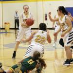 Homers Hannah Hatfield passes the ball to teammate Kelli Bishop after a scramble on the floor for the ball during a Saturday, Jan. 11, 2020 basketball game against Seward in the Alice Witte Gymnasium in Homer, Alaska. (Photo by Megan Pacer/Homer News)