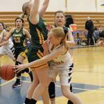 Homers Kelli Bishop passes the ball around Sewards Katelyn Lemme during a Saturday, Jan. 11, 2020 basketball game between the two schools at the Alice Witte Gymnasium in Homer, Alaska. (Photo by Megan Pacer/Homer News)