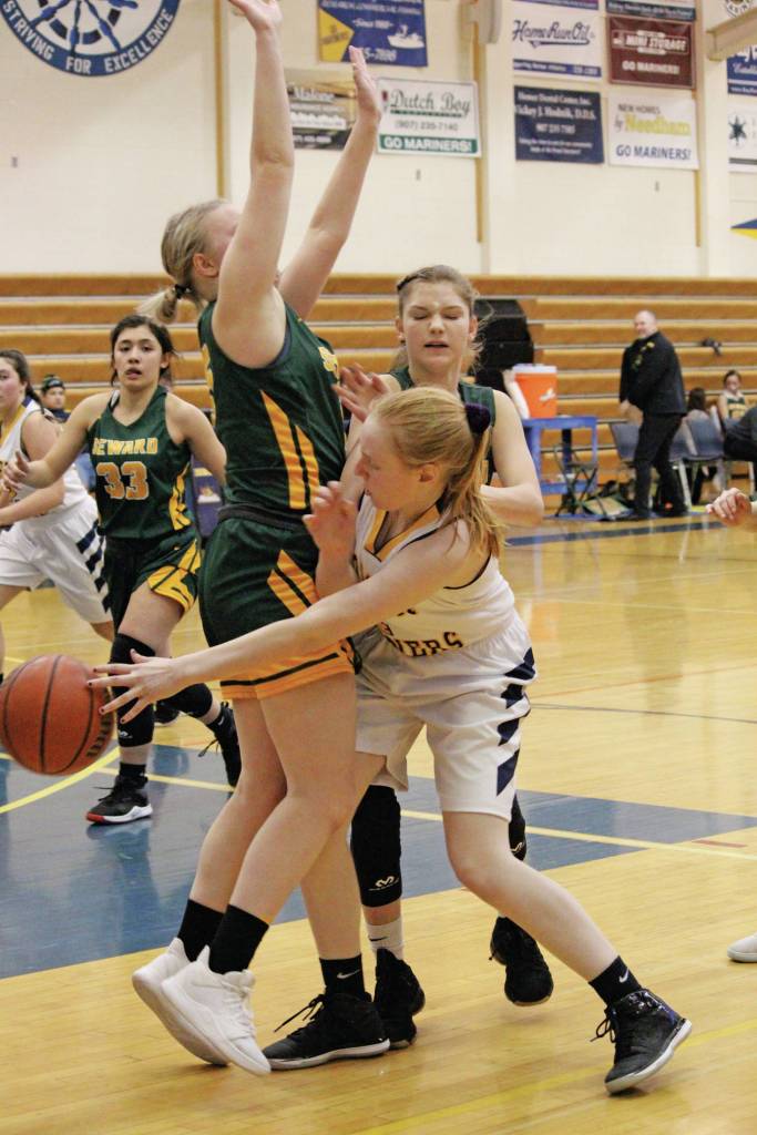 Homers Kelli Bishop passes the ball around Sewards Katelyn Lemme during a Saturday, Jan. 11, 2020 basketball game between the two schools at the Alice Witte Gymnasium in Homer, Alaska. (Photo by Megan Pacer/Homer News)