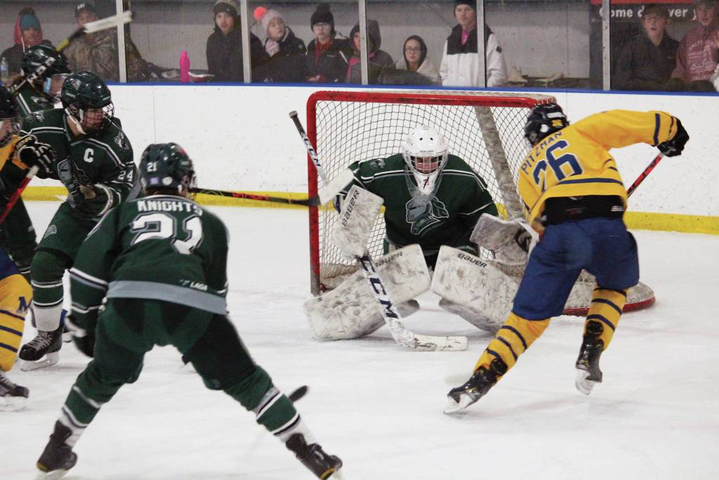 Photo by Megan Pacer/Homer News                                 Homers Ethan Pitzman prepares to take a shot at Colonys goalkeeper, Bryant Marks, during a Friday, Jan. 10, 2020 hockey game between the two schools at Kevin Bell Arena in Homer, Alaska.