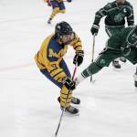 Homers Alden Ross takes the puck down the ice under pressure from Colony High Schools Kaden Ketchum during a Friday, Jan. 10, 2020 hockey game at Kevin Bell Arena in Homer, Alaska. (Photo by Megan Pacer/Homer News)