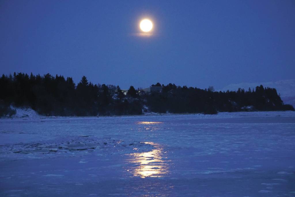 The fulll moon rises on Friday evening, Jan. 10, 2020, over Mud Bay in Homer, Alaska. (Photo by Michael Armstrong/Homer News)