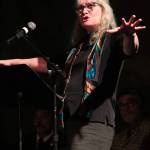 Marie McCarty speaks about Gary Thomas, a Homer man killed last week in a water heater explosion, during a Sunday, Jan. 19, 2020 memorial for him at Homer Mariner Theatre at Homer High School in Homer, Alaska. Thomas often volunteered as an auctioneer for the Kachemak Heritage Land Trust and other organizations having live auctions. (Photo by Megan Pacer/Homer News)