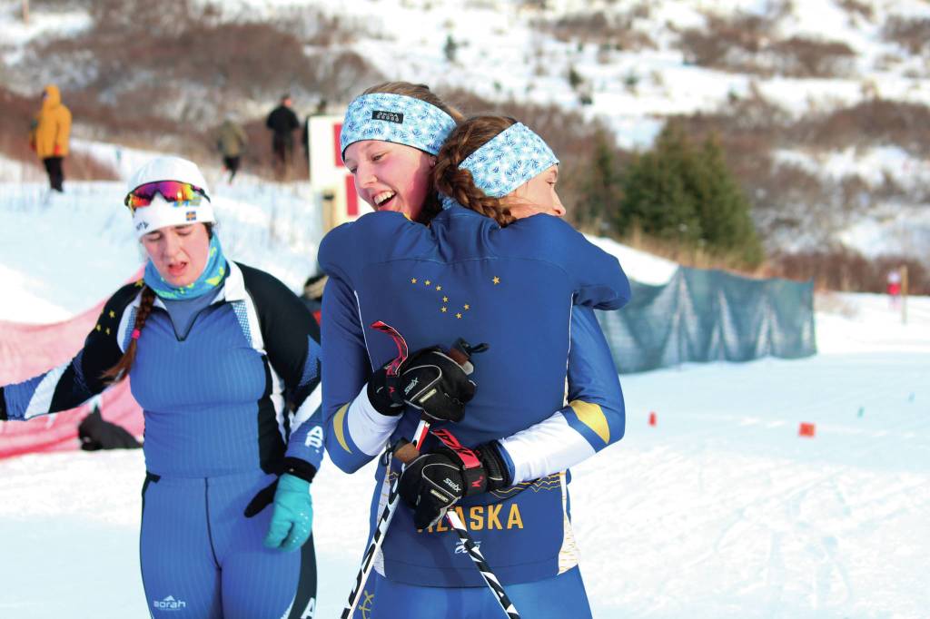 Homers Autumn Daigle (foreground) and Zoe Stonorov embrace after Stonorovs finish at one of the Besh Cup Races on Sunday, Jan. 19, 2020 at the Lookout Mountain Trails on Ohlson Mountain Road near Homer, Alaska. (Photo by Megan Pacer/Homer News)