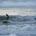 A man surfs off the Homer Spit on Thursday afternoon, Jan. 30, 2020, in Homer, Alaska. (Photo by MIchael Armstrong/Homer News)