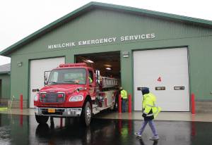 Former Ninilchik Fire Chief David Bear moves the fire truck out of the new Ninilchik Emergency Services building on Aug. 9, 2014. (Homer News file photo)