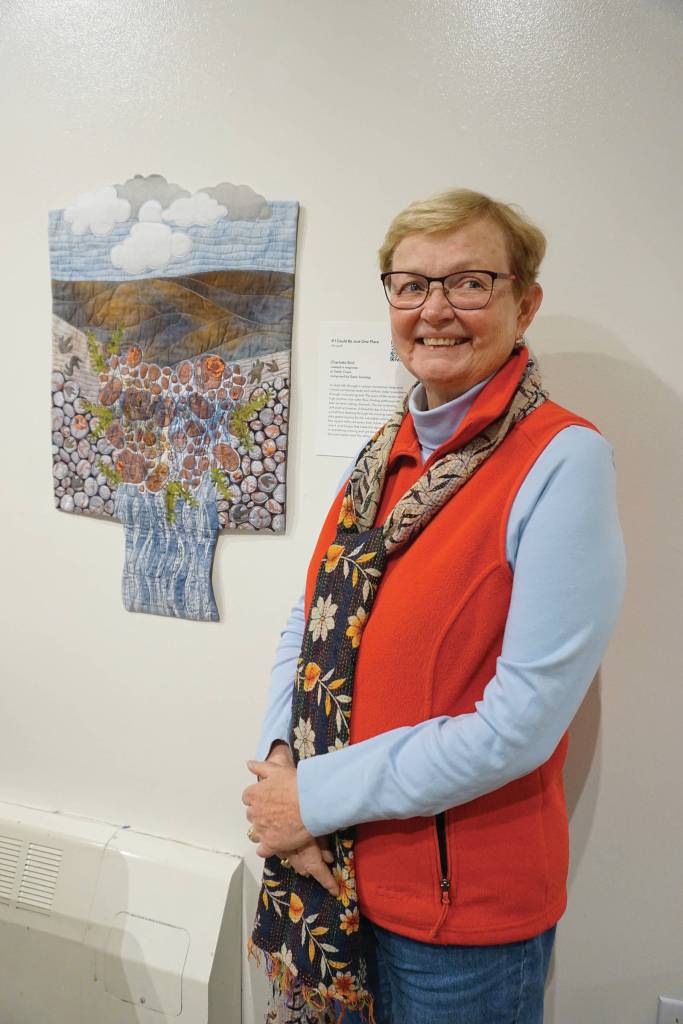 Charlotte Bird stands next to her If I Could Be Just One Place on Feb. 4, 2020, at the Pratt Museum in Homer, Alaska. It was created in response to composer Dawn Sonntags Tattler Creek. Brids quilt is part of Denali Artists Respond to Music Inspired by Wilderness, a collaboration between artists and composers showing Feb. 7-May. 25, 2020, at the Pratt Museum in Homer, Alaska. (Photo by Michael Armstrong/Homer News)                                Charlotte Bird stands next to her If I Could Be Just One Place on Feb. 4, 2020, at the Pratt Museum in Homer, Alaska. It was created in response to composer Dawn Sonntags Tattler Creek. Birds quilt is part of Denali Artists Respond to Music Inspired by Wilderness, a collaboration between artists and composers showing Feb. 7-May 25, 2020, at the Pratt. (Photo by Michael Armstrong/Homer News)