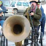 A parade participant plays a bike horn with the Krewe of Gambrinus float during this years Homer Winter Carnival Parade on Saturday, Feb. 8, 2020 in Homer, Alaska. (Photo by Megan Pacer/Homer News)