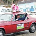 Former Mayor Bryan Zak drives the car for the float representing Mayor Ken Castners office during this years Homer Winter Carnival Parade on Saturday, Feb. 8, 2020 on Pioneer Avenue in Homer, Alaska. (Photo by Megan Pacer/Homer News)