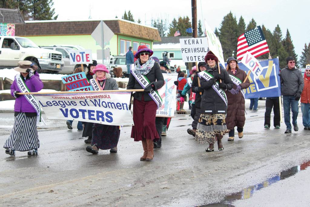 Representatives of the Kenai Peninsula League of Women Voters, based on the central peninsula, walk in this years Homer Winter Carnival Parade on Saturday, Feb. 8, 2020 on Pioneer Avenue in Homer, Alaska. (Photo by Megan Pacer/Homer News)