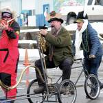 A parade participant plays a bike horn with the Krewe of Gambrinus float during this years Homer Winter Carnival Parade on Saturday, Feb. 8, 2020 in Homer, Alaska. (Photo by Megan Pacer/Homer News)