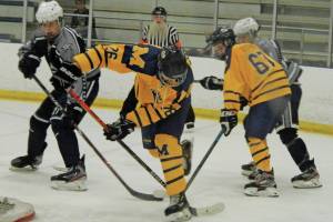Homers Ethan Pitzman (26) and Matey Reutov (67) battle with Soldotnas Dylan Dahlgren (left) for the puck during the second period of the Saturday, Feb. 8, 2020 final of the ASAA/First National Cup Division II State Hockey Championships at the University of Alaska Fairbanks Patty Ice Arena in Fairbanks, Alaska. (Photo by Danny Martin/News-Miner)