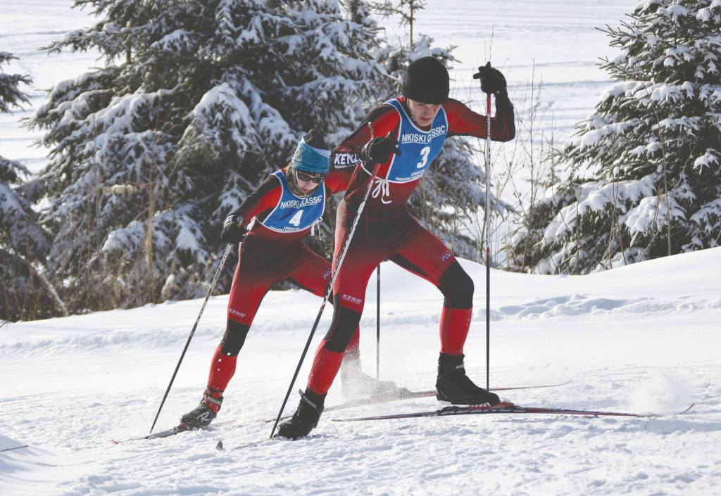 Kenais Mathew Grybowski and Nathan Haakenson climb a hill at the Kenai Peninsula Borough Nordic ski championships Saturday at Tsalteshi Trails just outside of Soldotna. (Photo by Jeff Helminiak/Peninsula Clarion)