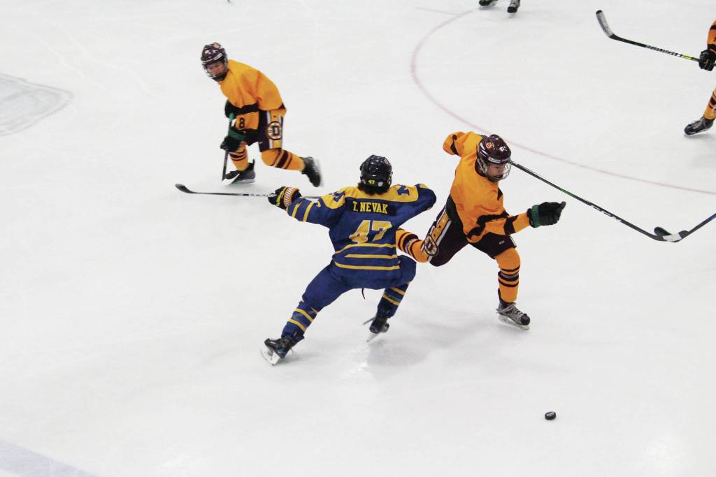 Dimonds Tyler Christiansen skates around Homers Toby Nevak during a Friday, Feb. 14, 2020 game at the 2020 ASAA First National Cup Division I Hockey State Championship at the Curtis D. Menard Memorial Sports Center in Wasilla, Alaska. (Photo by Megan Pacer/Homer News)
