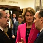 photo by Peter Segall | Juneau Empire                                Sen. Lyman Hoffman, D-Bethel, left, and Sen. Donny Olson, D-Golovin, speak with U.S. Sen. Lisa Murkowski, R-Alaska in the halls of the Alaska Capitol on Tuesday.