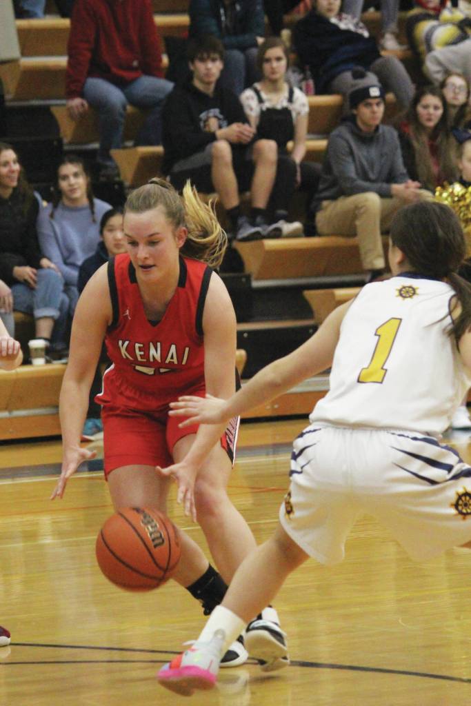 Kenais Jaiden Streiff dribbles past Homers Sailey Rhodes during a Wednesday, Feb. 19, 2020 basketball game at Homer High School in Homer, Alaska. (Photo by Megan Pacer/Homer News)