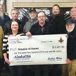 Members of the Kachemak Bay Masonic Club, in cooperation with Homer Elks #2127, held its 5th Annual Masonic Awareness Spaghetti Feed Fundraiser on Jan. 25, 2020, at the Homer Elks Lodge to benefit Hospice of Homer in Homer, Alaska. Proceeds to Hospice totaled $2,451.86. Masons pose here with a celebratory check presented to Hospice of Homer officials. They are, front row, right to left: Doug Baily, Hospice of Homer Executive Director Jessica Golden, Joshua Riley, Hospice of Homer Board member Michael Hawfield, and Tom Stroozas; back row, from left to right, Grady Svoboda, Dave Rush, Barry Haynes, Greg Martin and Jody Murdock. (Photo courtesy of Kachemak Bay Masonic Club)