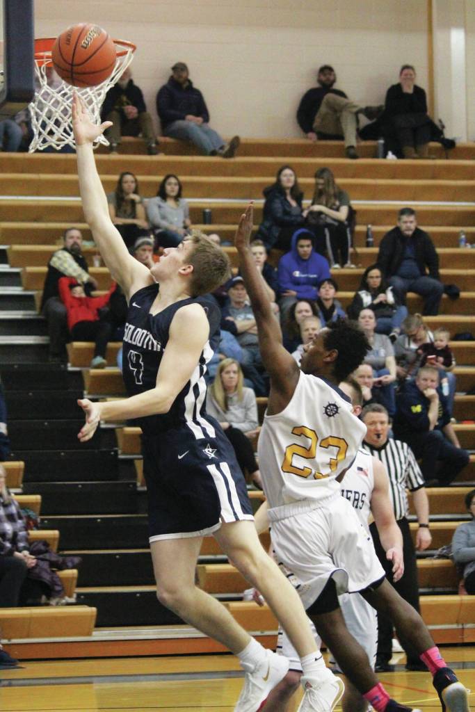 Homers Eyoab Knapp follows Soldotnas Tyler Morrison as he goes up for a basket during a Tuesday, Feb. 25, 2020 basketball game in the Alice Witte Gymnasium in Homer, Alaska. (Photo by Megan Pacer/Homer News)