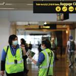 A pair of workers at Seattle-Tacoma International Airport wear masks Tuesday, March 3, 2020, in SeaTac, Wash. Six of the 18 Western Washington residents with the coronavirus have died as health officials rush to test more suspected cases and communities brace for spread of the disease. All confirmed cases of the virus in Washington are in Snohomish and King counties. (AP Photo/Elaine Thompson)
