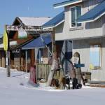 Snow drifts cover the parking lot of boarded-up cafes and shops on the Homer Spit on Feb, 24, 2020, in Homer, Alaska. Except for the Salty Dawg, Coal Point Seafoods and Lands End Resort, most of the Spit is closed for the season. (Photo by Michael Armstrong/Homer News)
