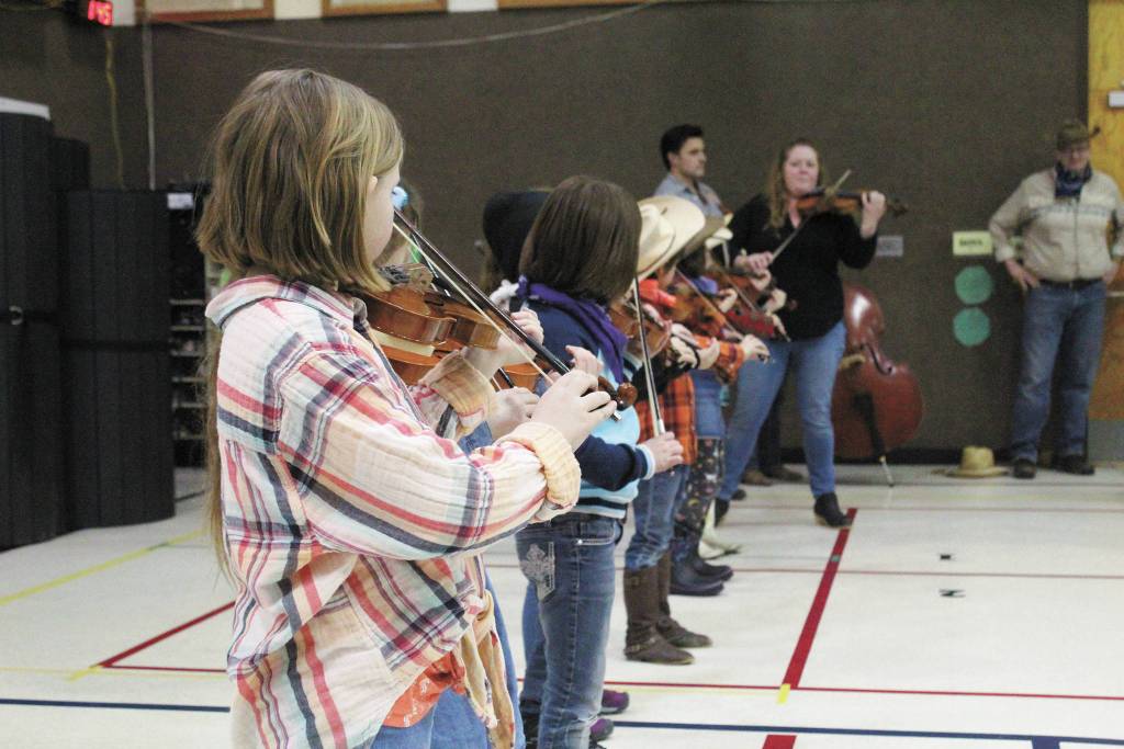 Members of the Paul Banks Preludes, under the direction of Katy Klann perform at a Thursday, March 5, 2020 assembly to celebrate the end of the schools annual read-a-thon at Paul Banks Elementary School in Homer, Alaska. (Photo by Megan Pacer/Homer News)