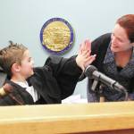 Bride Seifert, Homers first Superior Court judge, high fives 5-year-old Atticus Torres after he called for order in the courtroom during an an open house for the community Thursday, March 5, 2020 at the Homer Court in Homer, Alaska. (Photo by Megan Pacer/Homer News)