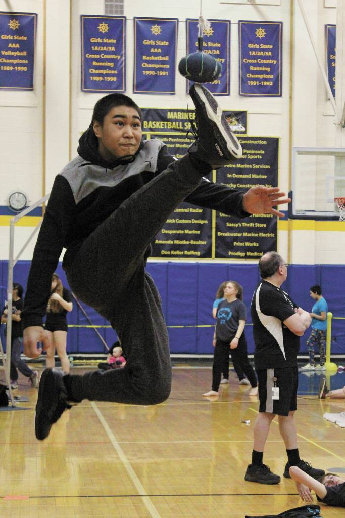 James Mishakoff of Tebughna School in Tyonek just misses connecting with the ball during the one-foot high kick event at the Kachemak Bay Traditional Games, a Native Youth Olympics invite, Saturday, March 7, 2020 at Homer High School in Homer, Alaska. (Photo by Megan Pacer/Homer News)